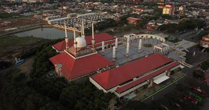 Circling drone shot of the great Mosque of Central Java (MAJT) in the afternoon. It have some pillars and some umbrela that is closed. Semarang, Central Java, Indonesia