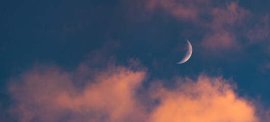 Sunset sky with large crescent moon, evening sky background