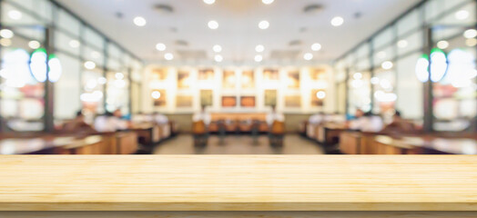 Empty wood table top with cafe restaurant interior blurred background