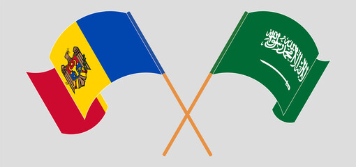 Crossed and waving flags of Moldova and Saudi Arabia