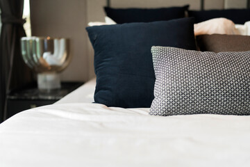 Bed maid-up with clean white pillows and bed sheets in beauty room. Close-up. Lens flair in...