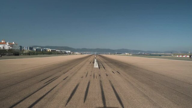 Empty airport runway with tire marks in Gibraltar, pedestal shot.