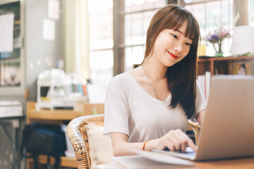 Young adult asian student woman stay at home and study online