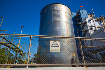 Obraz premium Tank stainless steel industrial for chemical production symbol beware acid.