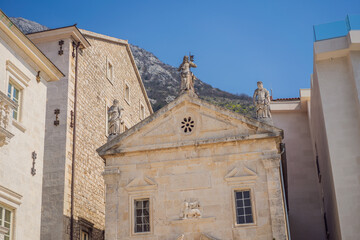 Fototapeta na wymiar Scenic panorama view of the historic town of Perast at famous Bay of Kotor with blooming flowers on a beautiful sunny day with blue sky and clouds in summer, Montenegro, southern Europe
