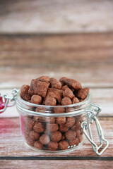 children's chocolate dry breakfast in the form of balls and pillows in a glass jar