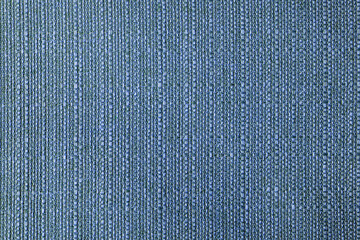 Close-up texture of natural blue coarse weave fabric or cloth. Fabric texture of natural cotton or linen textile material. Blue canvas background. Decorative fabric for upholstery, furniture, walls