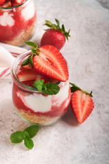 Strawberry Cheesecake. Cheesecake or trifle with strawberry in glass on old gray concrete background table background. Cheesecake without baking. Dessert. New York. Copy space. Food background.