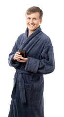 portrait of a man in a gray terry bathrobe. happy, healthy Man holds a mug of water. drinking more water is good for your health. better at home, stay home. quarantine. isolated.