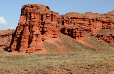 Landscape with red mountains Narman Peribacalari, formed due to erosion and weathering, against the blue sky with clouds, near the city of Erzurum, in the region of Eastern Anatolia, Turkey