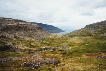 Scenic view of cliffs of Iceland against mountains and the North Atlantic Ocean beautiful landscape nature selective focus
