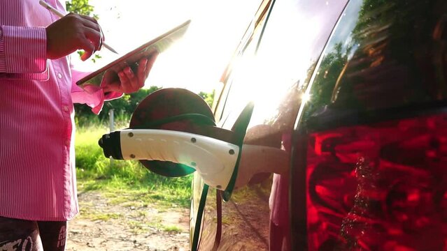 Footage Slow Motion: Electric car EV charging in charging station