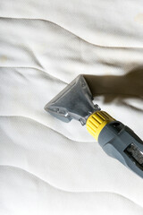 Cleaning the mattress with a vacuum cleaner