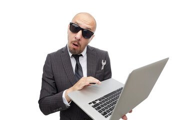 A man in suit with wrench holding laptop isolated on white background.  Support computer concept .