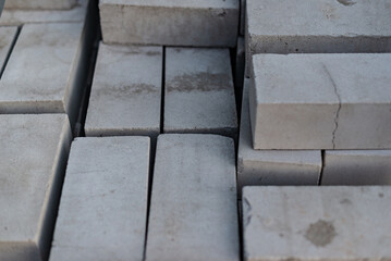 Lots of new white sand-lime air bricks in a stack close-up. Production of building materials