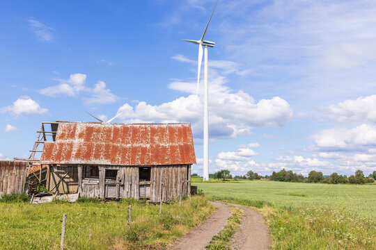 Rural old barn with a wind turbine in the countryside