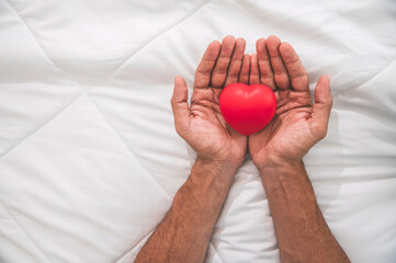 Hand of a man holding red heart, world heart day, world health day, love concept.