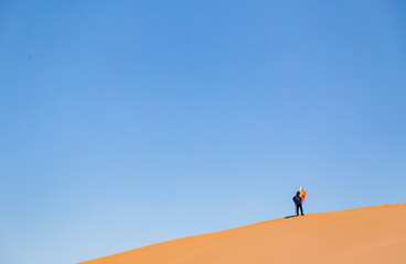 people in the desert under the blue sky