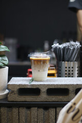 Closeup of Iced Caramel Macchiato at the coffee shop, Caramel Macchiato is a classic macchiato beverage. It consists of vanilla syrup, espresso, steamed milk, foam, and caramel drizzle