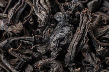 Dry black tea leaves close up. Macro background of tea production