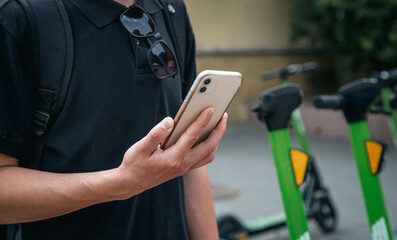 A man unlocks an e-scooter with his mobile phone.