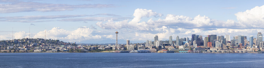 Downtown Seattle, Washington, United States of America. Panoramic View of the Modern City on the Pacific Ocean Coast. Cloudy Blue Sky.