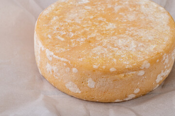 Artisanal Canastra cheese from Minas Gerais, Brazil over paper