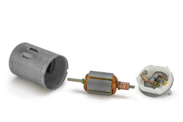 Disassembled dc motor parts on isolated white background