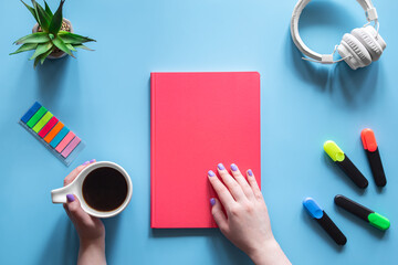 Flat lay composition on the theme of school and study with a pink notebook.