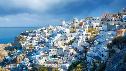 Oia village, Santorini, Greece. View of traditional houses in Santorini. Small narrow streets and rooftops of houses, churches and hotels. Panorama. Travel and vacation photography.