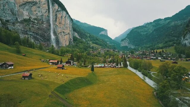 Lauterbrunnen town in Swiss Alps valley, Switzerland. Big waterfall