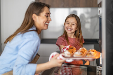 Mother and daughter havig fun in kitchen