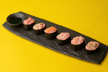 sushi on a black plate