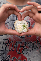 hand holding sushi