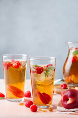 Fototapeta na wymiar Peach raspberry iced tea, summer refreshing drink, beverage, cocktail