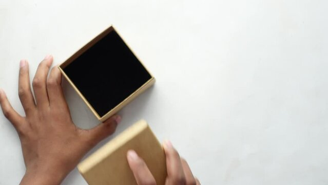 top view of person open a empty small gift box 