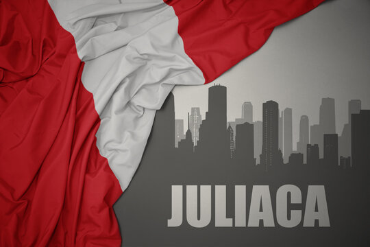 abstract silhouette of the city with text Juliaca near waving colorful national flag of peru on a gray background.