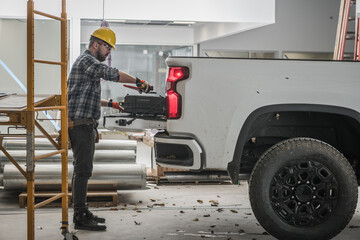 Construction Worker Loading Tools into the Pickup Car © Tomasz Zajda