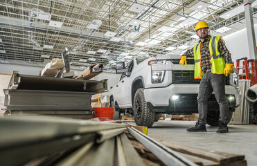 Worker Inside Developed Warehouse Building Staying Next to His Pickup Truck - obrazy, fototapety, plakaty