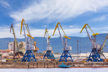 Cargo cranes in the river port in Yenisey river in Krasnoyarsk, Russia