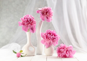 Bouquet of pink peonies in a vase on a wooden table. Gift Valentine's Day