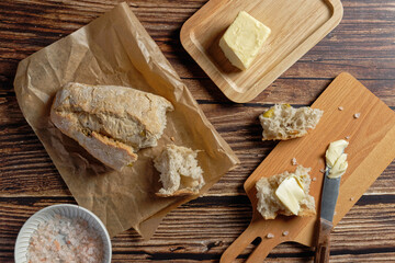 Fragments of baguette spread with butter.