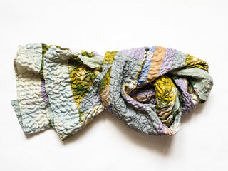 knotted patchwork scarf sewn from silk on table