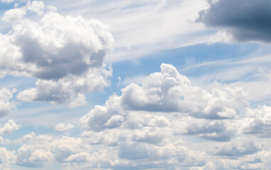 White clouds on the blue sky, bright background of the summer sky.