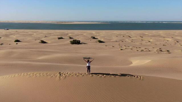 Standing on the highest sand dune overlooking the Nayla Lagoon in Morocco.