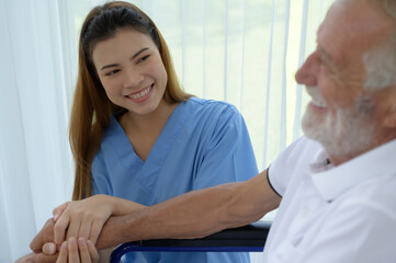 Doctor talking to elderly patient with symptoms of depression Look at nature outside the window in a special patient room.