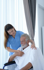 Doctor talking to elderly patient with symptoms of depression Look at nature outside the window in a special patient room.