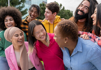 group of multiracial young people laughing on a sunny day - Cheerful group of best friends enjoying summer vacation together - Students, youth lifestyle and summer vacation concept