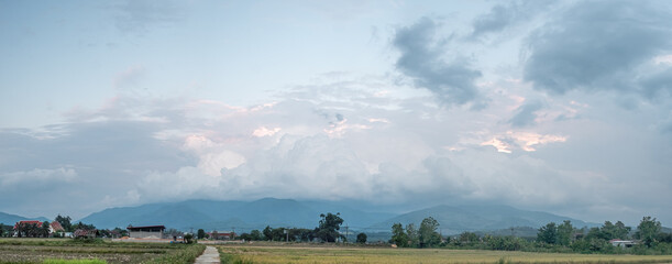 Storm clouds are forming over the top of the mountain.