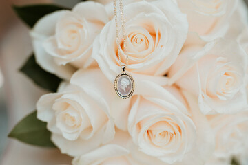 necklace in front of roses